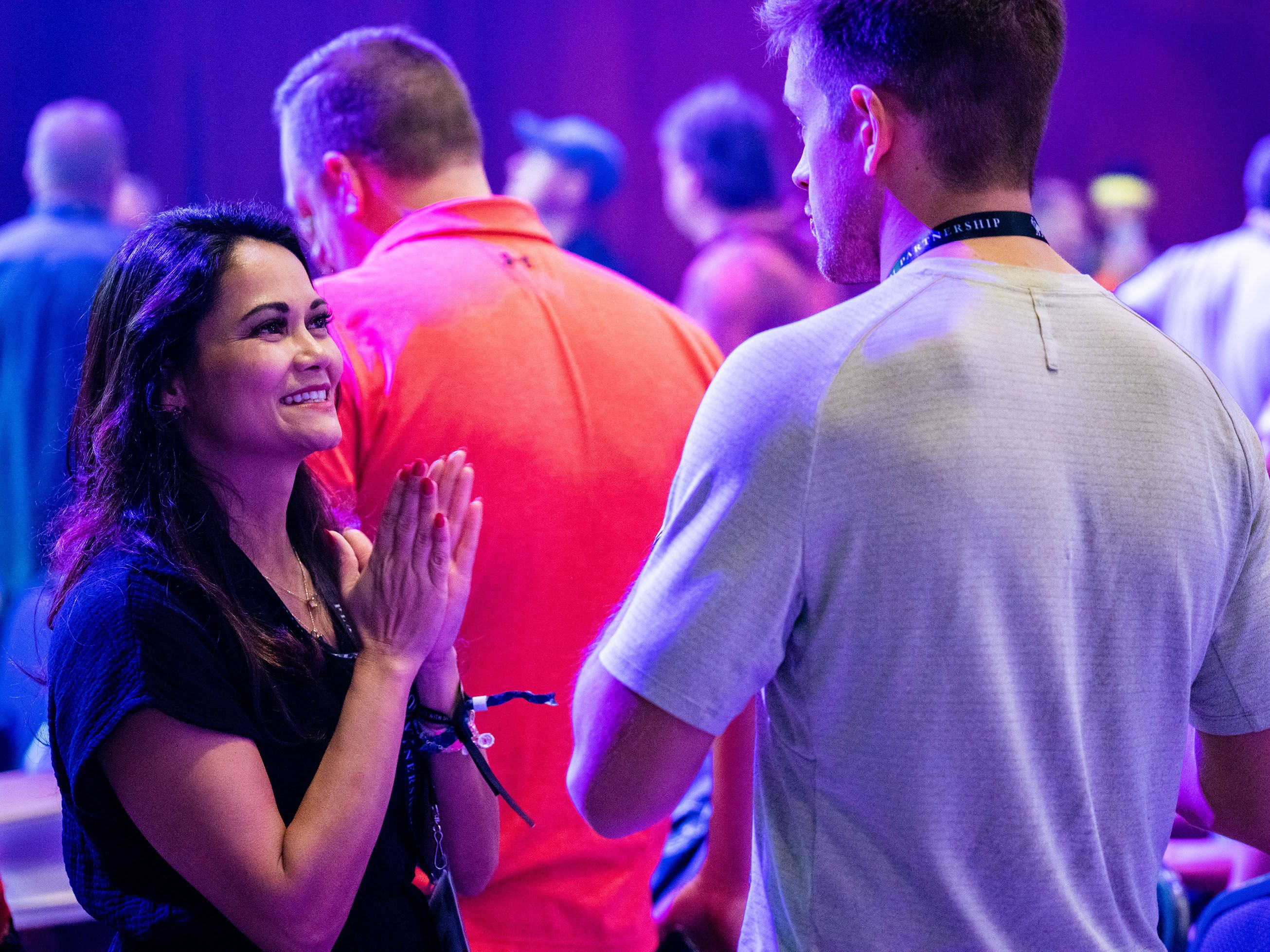 a man and a woman are standing next to each other in a crowd .