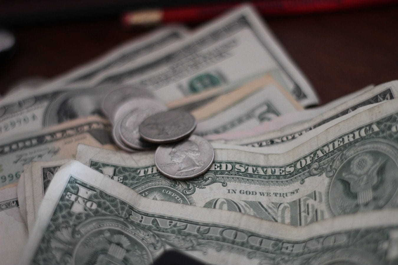 a pile of money and coins on a table .