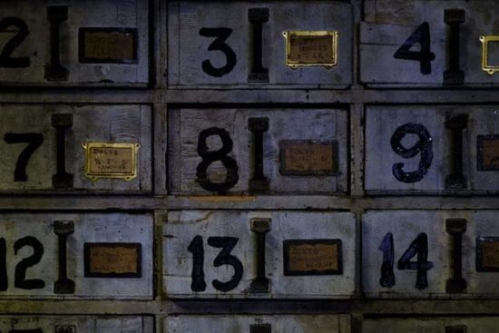 a wall filled with lots of drawers with numbers on them .
