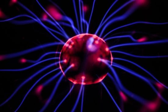 a close up of a plasma ball with glowing lines coming out of it .