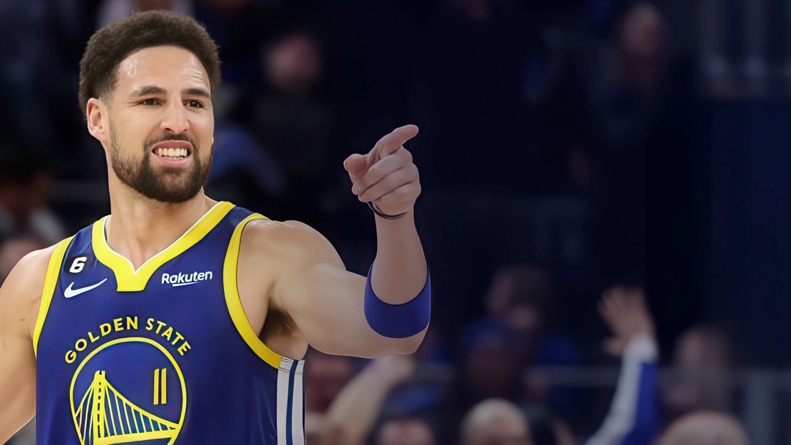 Klay Thompson basketball player for the golden state warriors is pointing at the crowd during a basketball game .