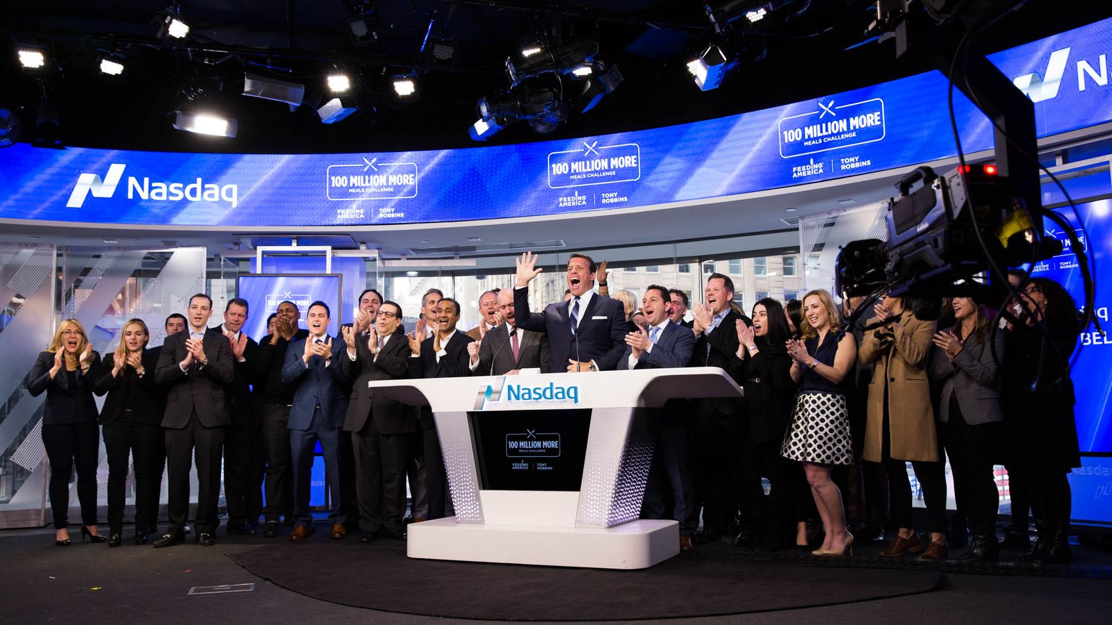 a group of people are standing around a table in a room .