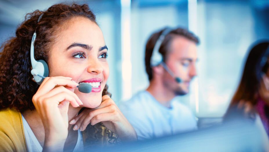 a woman is wearing a headset in a call center .
