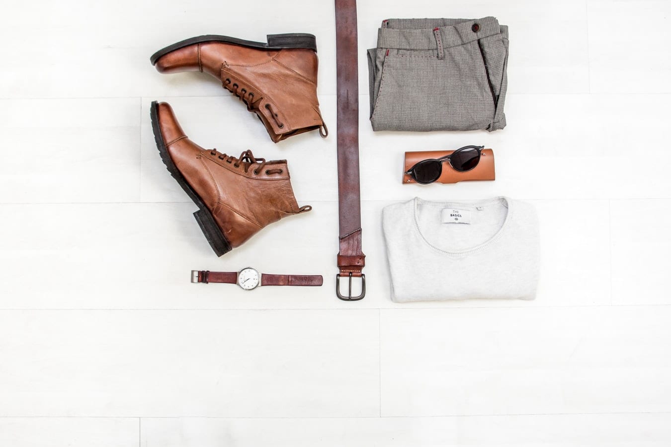 a pair of brown boots , a watch , a belt