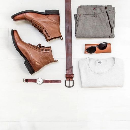 a pair of brown boots , a watch , a belt