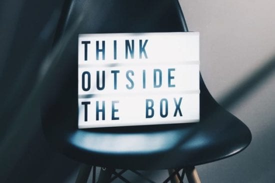 a light box on a chair that says `` think outside the box '' .