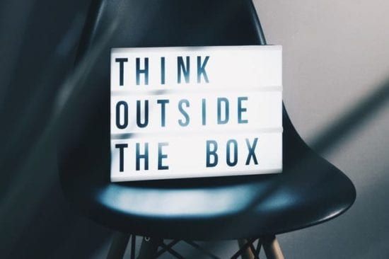 a light box on a chair that says `` think outside the box '' .