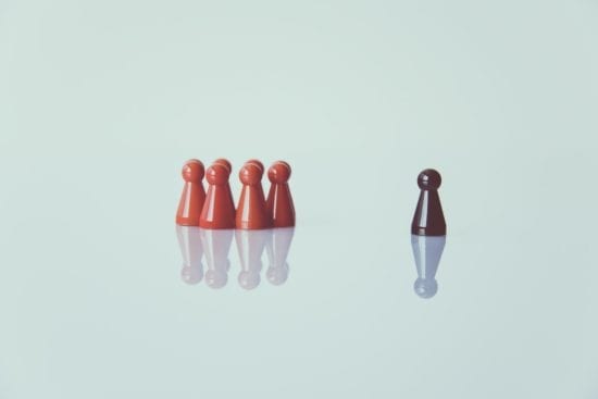 a group of red and black game pieces are lined up next to each other on a table .