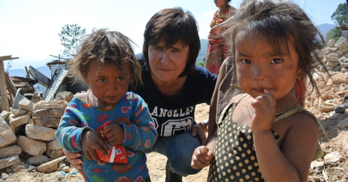 The gift of drive image of woman and 2 small girls amidst rubble