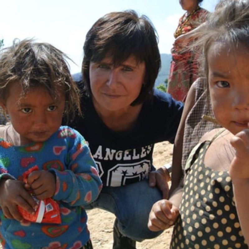 The gift of drive image of woman and 2 small girls amidst rubble