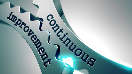 a close up of a metal gear with the words `` continuous improvement '' written on it .