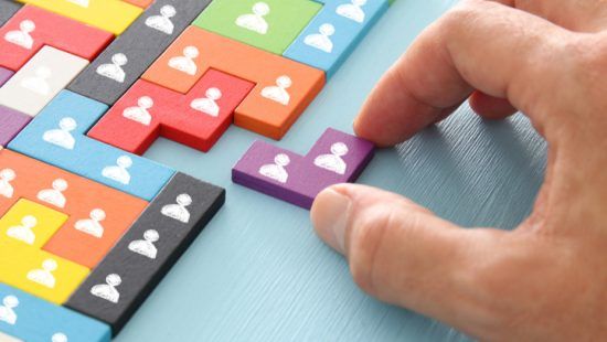 a person is playing a game of tetris with a purple piece .