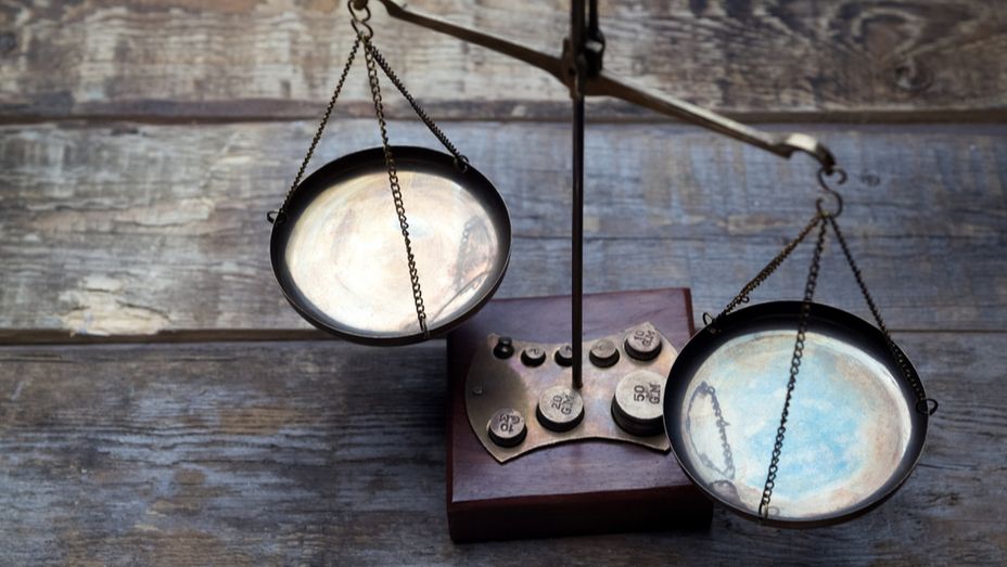 a pair of scales sitting on top of a wooden table .
