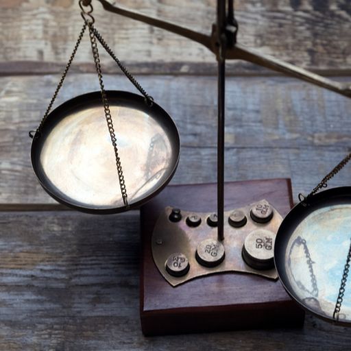 a pair of scales sitting on top of a wooden table .