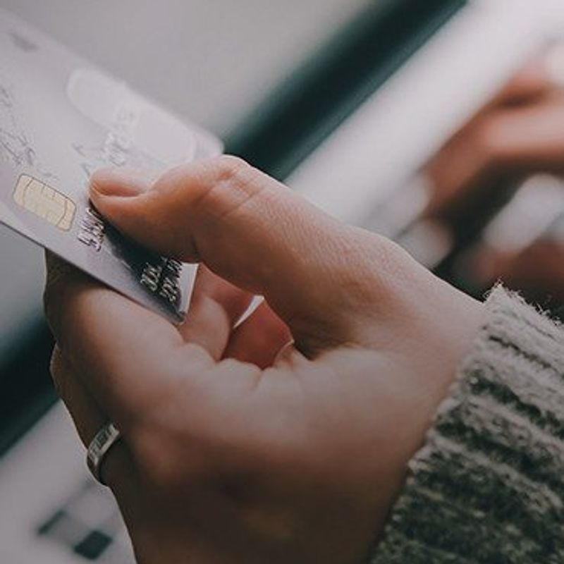 Building a brand on customer service image of hand holding credit card