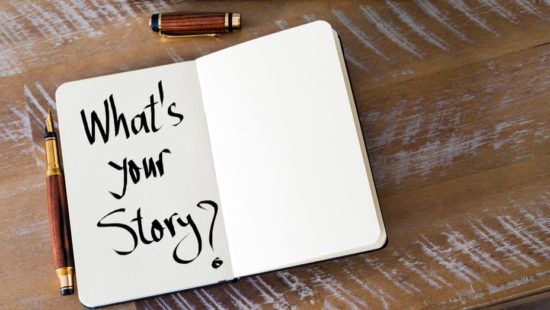a notebook with the words `` what 's your story '' written on it is sitting on a wooden table next to a pen .