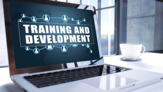 a laptop computer is open to a screen that says `` training and development '' .