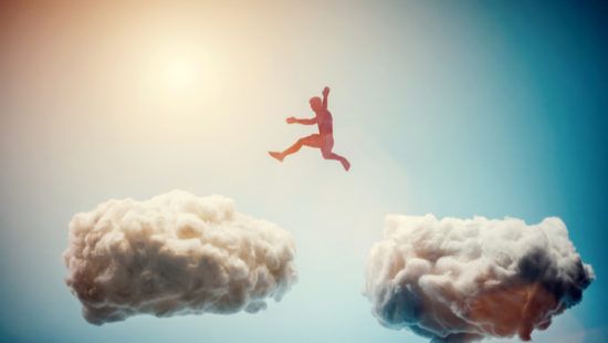 a man is jumping over a cloud in the sky .