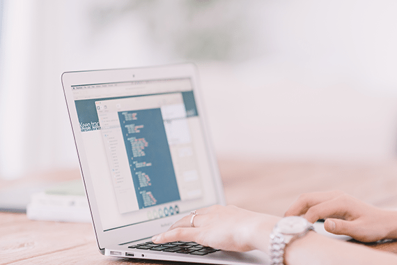 a person is typing on a laptop that says idea box on the screen
