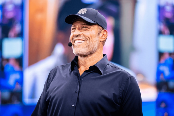 Tony Robbins wearing a hat with a clover on it