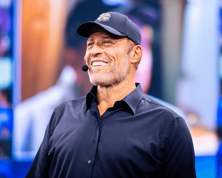 Tony Robbins wearing a hat with a clover on it