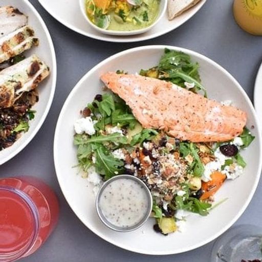 a table topped with plates of food and drinks .