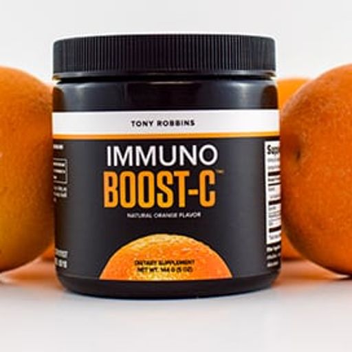 a jar of immuno boost c is sitting on a table next to oranges .