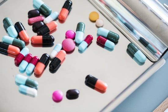 a tray of pills and capsules on a table .