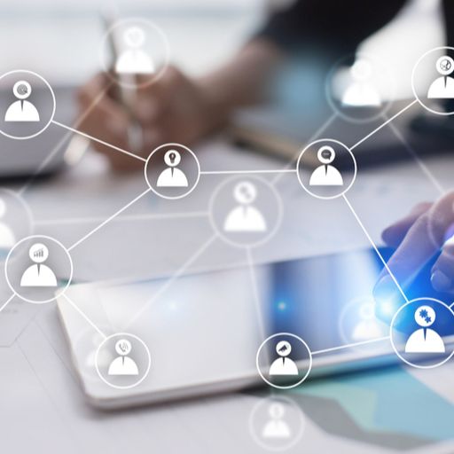 a person is using a tablet with a network of people on it .