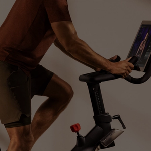 Founder & CEO of Peloton Talks Heart, Hunger & Health image of man on Peloton
