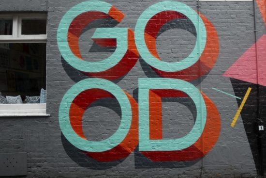 a brick wall with the words `` go od '' painted on it .