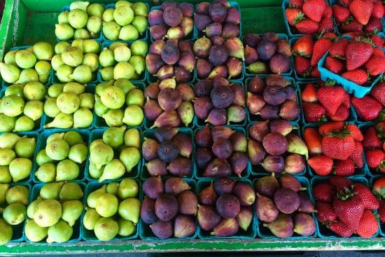 there are many different types of figs and strawberries on display .