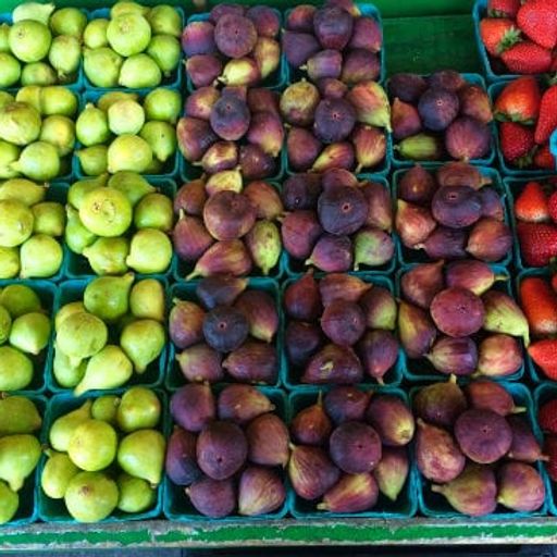 there are many different types of figs and strawberries on display .