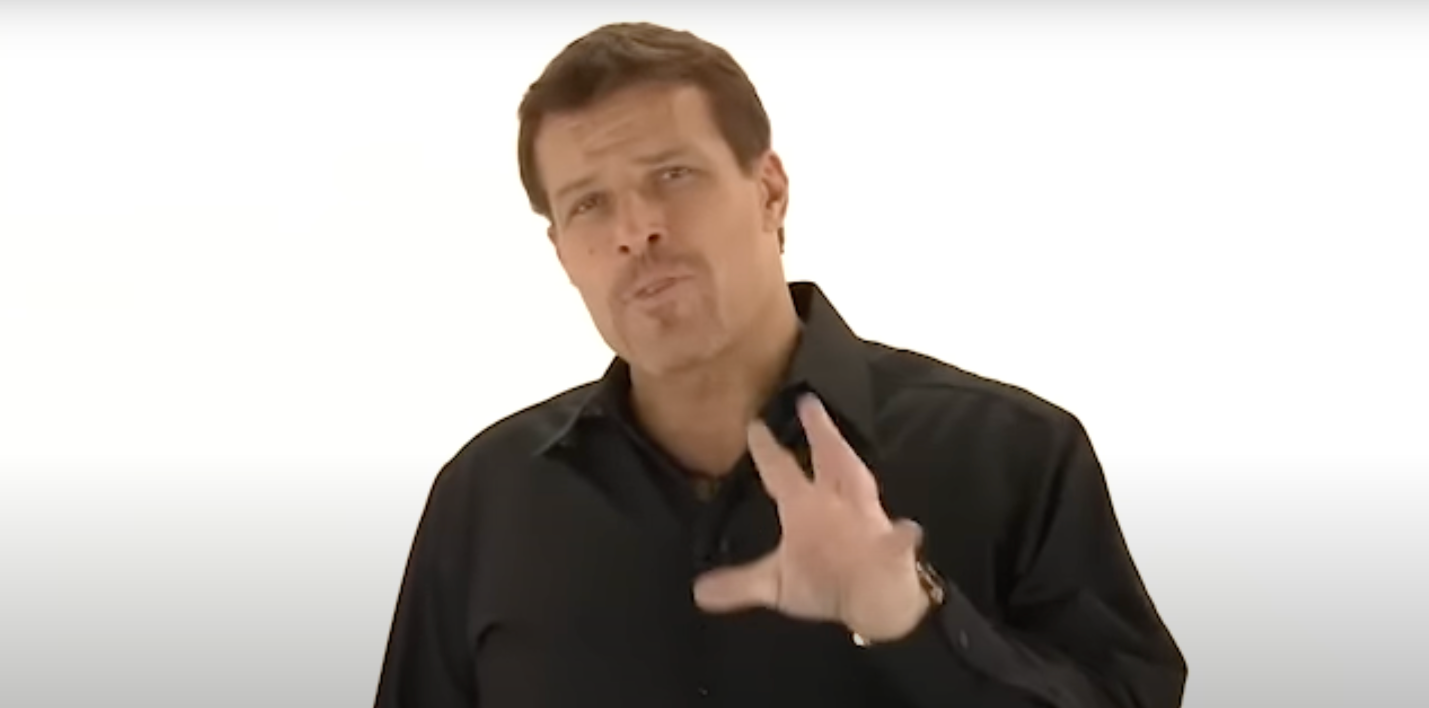 a man in a black shirt is making a hand gesture