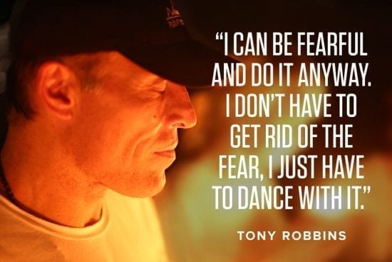 a man is wearing a hat and a quote from tony robbins