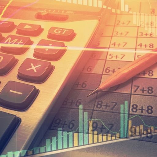 a calculator , pencil , and graph are on a table .
