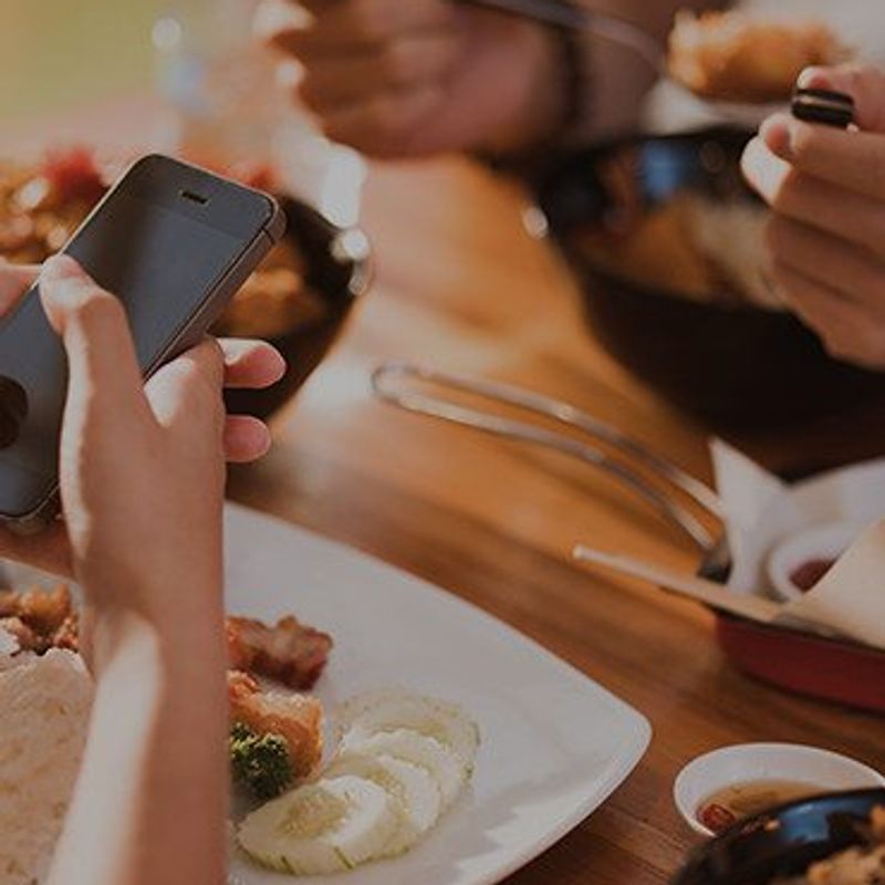 Payback for Venmo close up image of hands over dinner plates with phones