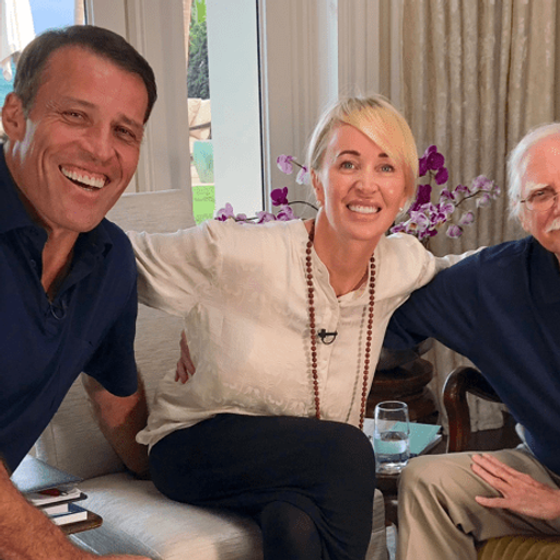 two men and a woman are posing for a picture in a living room