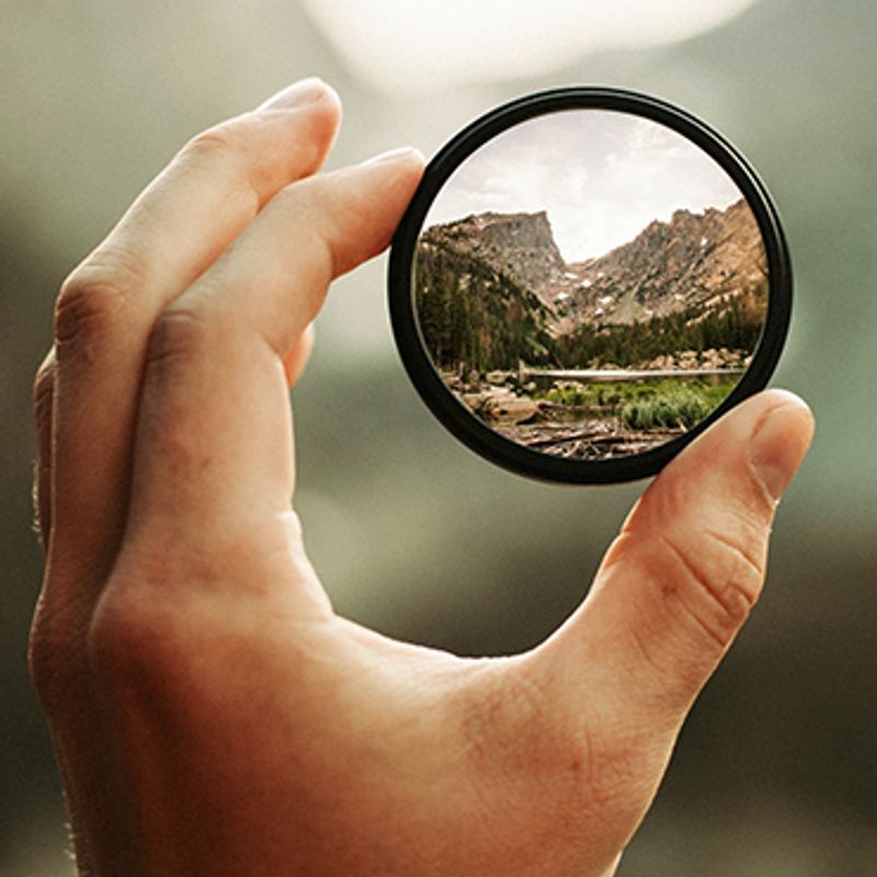 How to Guard Your Mind image of hand holding magnifier looking at mountains
