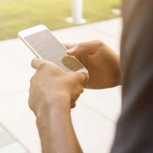 a person is holding a cell phone in their hands .