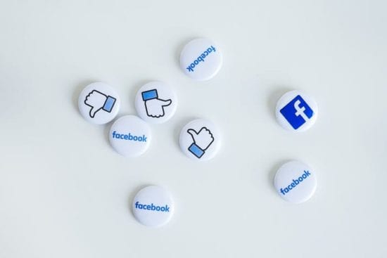 a bunch of facebook buttons on a white surface .