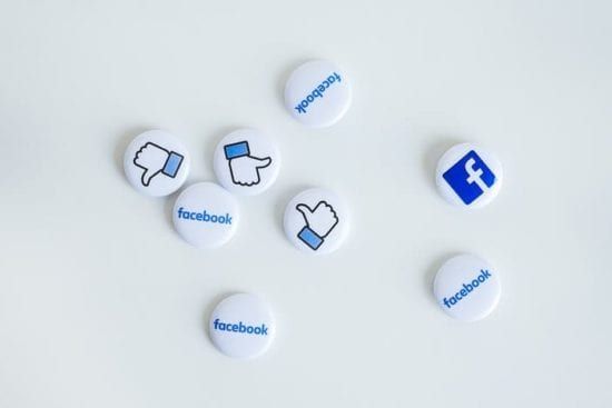 a bunch of facebook buttons on a white surface .