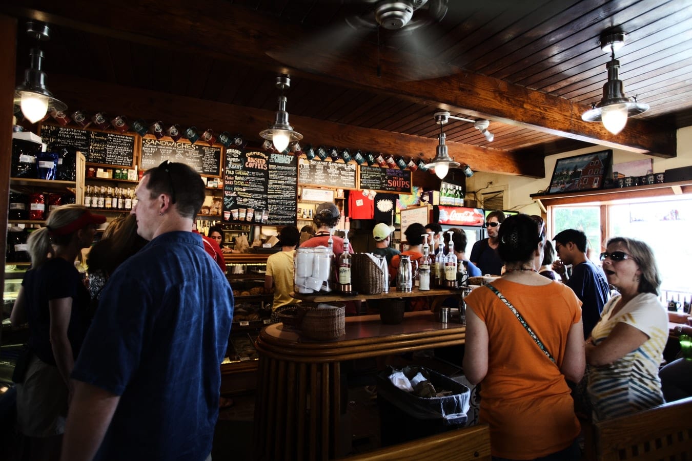 a group of people are standing in line at a restaurant .