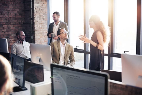 a group of people are having a meeting in an office .