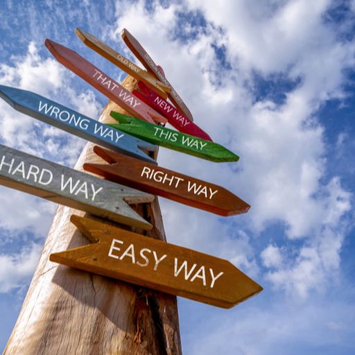 a wooden signpost with arrows pointing in different directions .