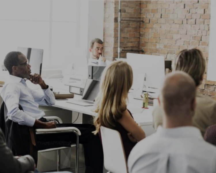 a woman is giving a presentation to a group of people