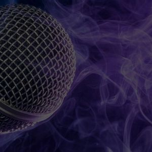 The Mic is Mightier than the Sword closeup image of a microphone with smoke background