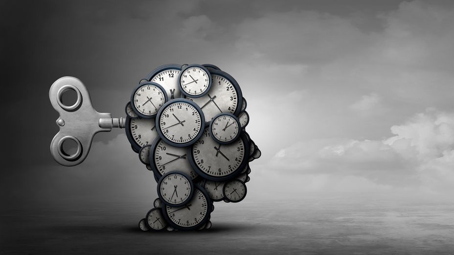 a bunch of clocks are stacked on top of each other in the shape of a person 's head .
