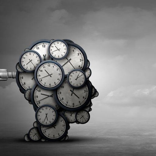 a bunch of clocks are stacked on top of each other in the shape of a person 's head .