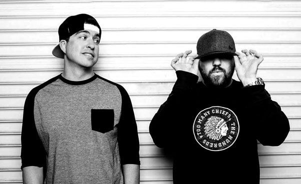 a black and white photo of two men standing next to each other .